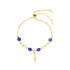 The Blue Evil Eye and Figa Hand Charm Bracelet with its adjustable box chain features a central figa hand charm surrounded by decorative gold beads and three blue beads, embodying spiritual symbolism and protection.